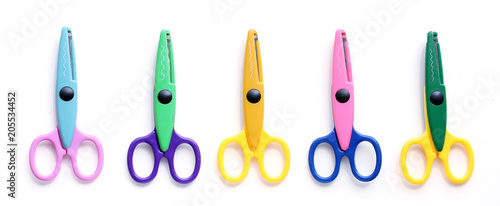Five children's pinking shears in a row