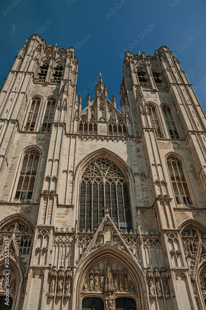 Fototapeta premium Gothic facade of St. Michael and St. Gudula’s Cathedral and blue sunny sky in Brussels. Vibrant and friendly, is the country’s capital and administrative center of the EU. Central Belgium.