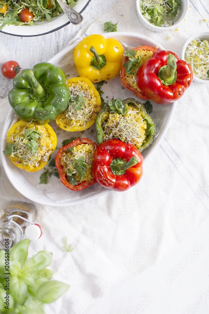 Rice And Pumpkin Stuffed Peppers baked in a white dish Rice And Pumpkin Stuffed Peppers baked in a white dish