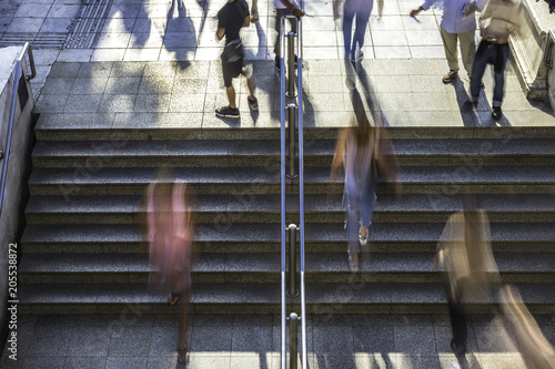 Overhead blurred people walking up and down the steps