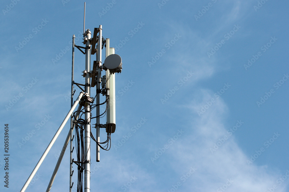 Cell antenna repeater on blue sky background Cell antenna repeater on blue sky background