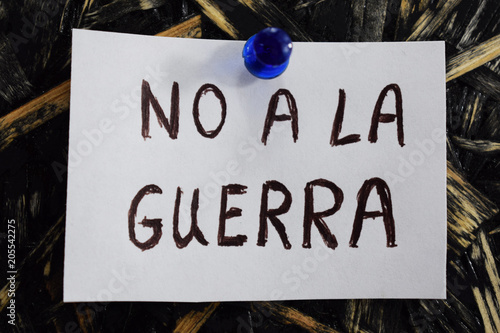 no a la guerra written in Spanish, means to not to the war, on a white sheet of paper.