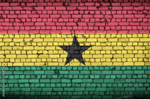 Ghana flag is painted onto an old brick wall photo