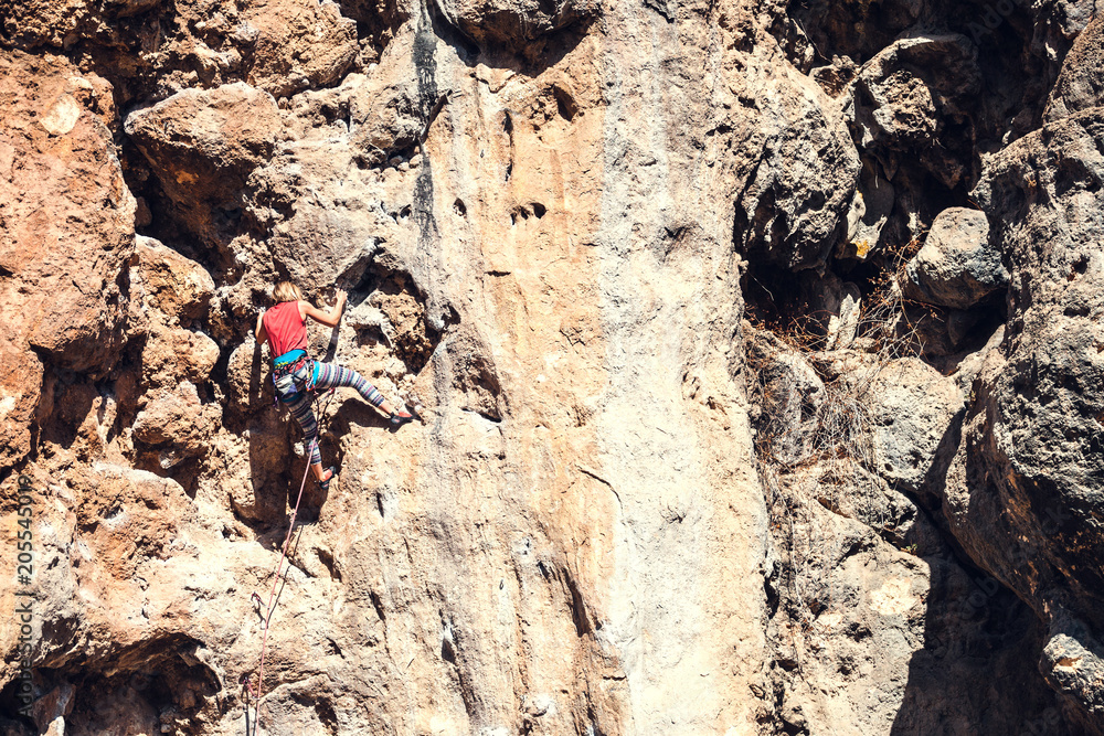 A climber climbs the rock.