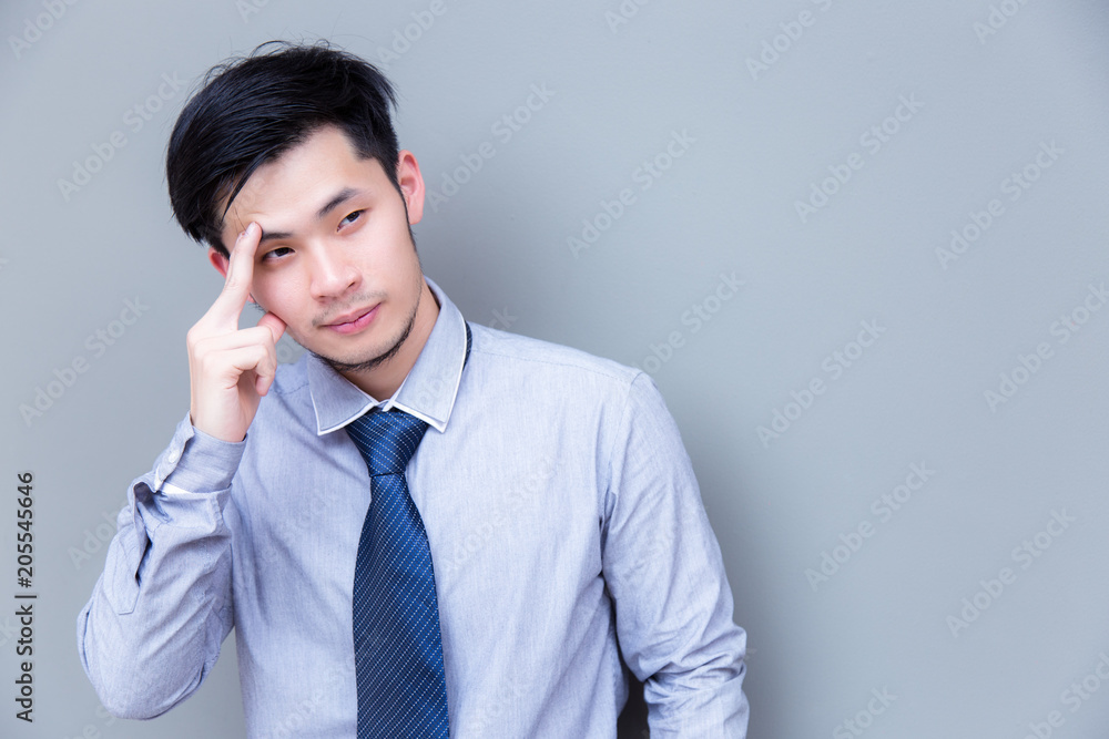 Portrait charming handsome businessman: Attractive guy is thinking how to do his best of working. Asia man looks so smart. Asian guy wears necktie and shirt. Handsome business man look at copy space Portrait charming handsome businessman: Attractive guy is thinking how to do his best of working. Asia man looks so smart. Asian guy wears necktie and shirt. Handsome business man look at copy space
