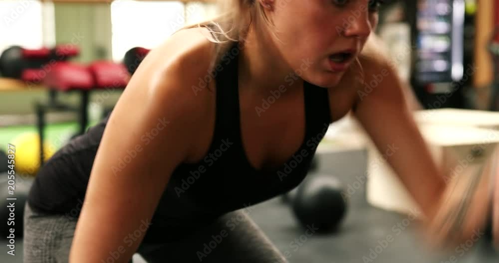 Fit young woman working out with ropes at the gym Fit young woman working out with ropes at the gym