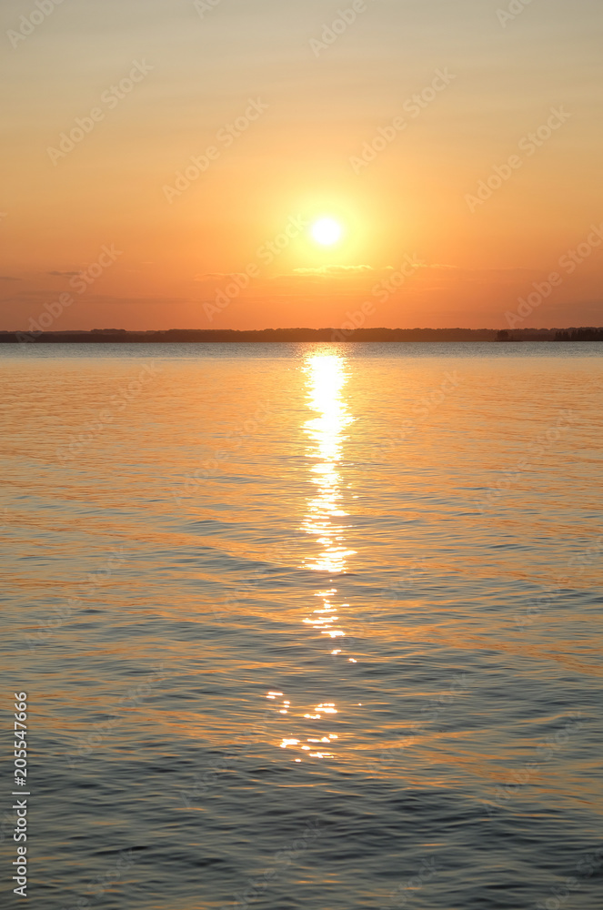 Beautiful bright orange summer sunset on the sea. Sun and solar