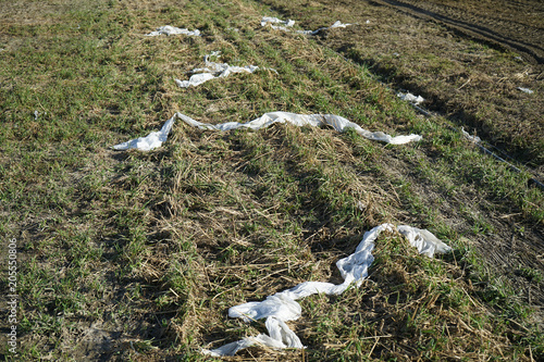 Environmental pollution, plastic waste on the field. photo