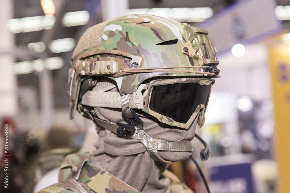 Fototapeta premium Army combat helmet are on, his face closed by using optical sights and night vision