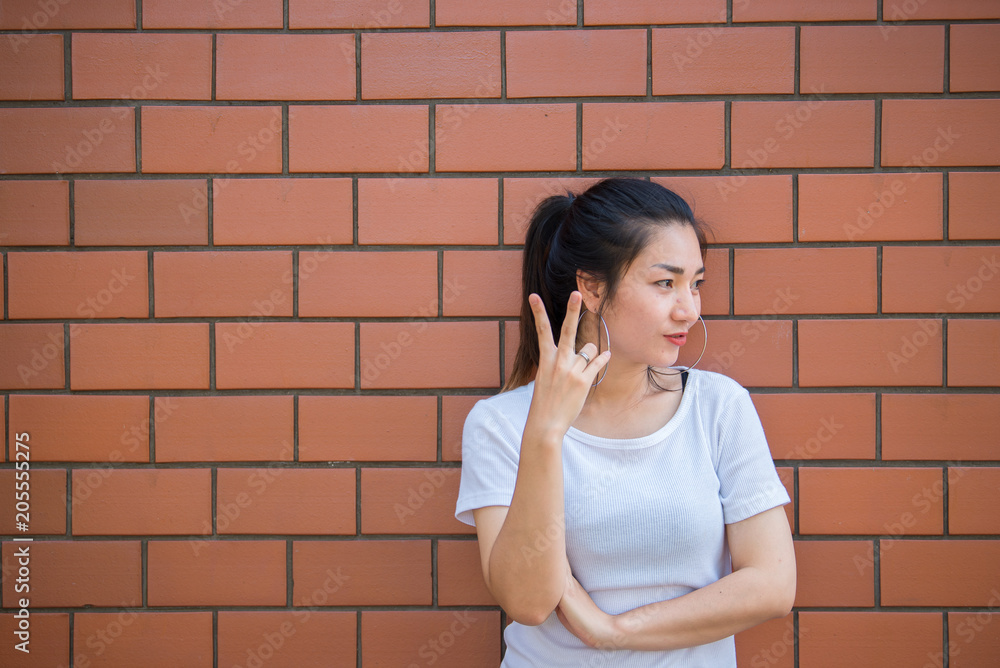 Portrait of beautiful asian chic girl pose for take a picture on brick wall,Lifestyle of teen thailand people,Modern woman happy concept Portrait of beautiful asian chic girl pose for take a picture on brick wall,Lifestyle of teen thailand people,Modern woman happy concept