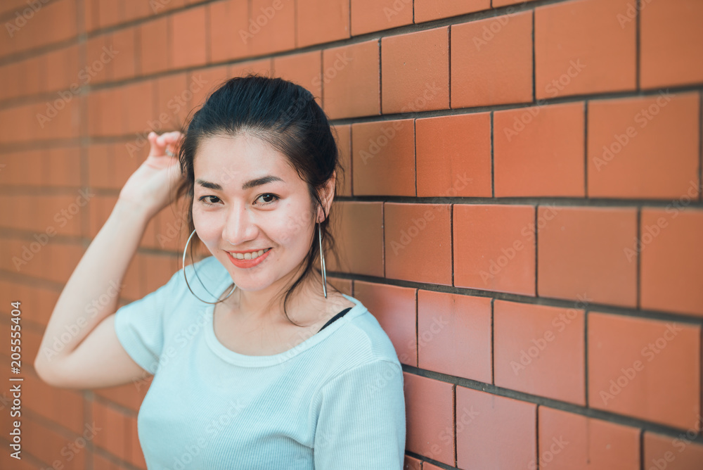 Portrait of beautiful asian chic girl pose for take a picture on brick wall,Lifestyle of teen thailand people,Modern woman happy concept Portrait of beautiful asian chic girl pose for take a picture on brick wall,Lifestyle of teen thailand people,Modern woman happy concept