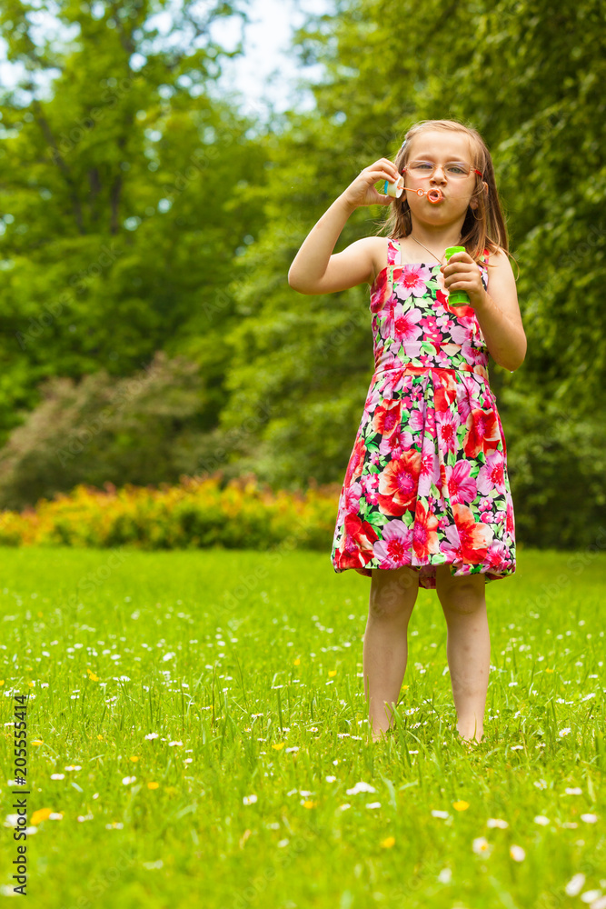 Little girl child blowing soap bubbles outdoor. Little girl child blowing soap bubbles outdoor.
