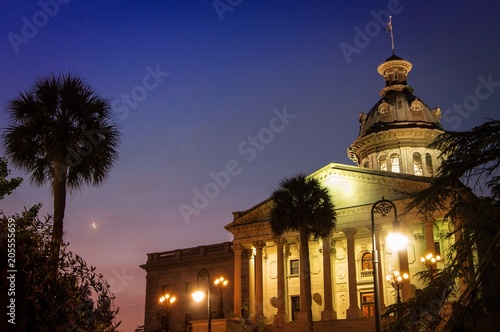 South Carolina Capital Building at sunrise with crescent moon and palmetto trees photo