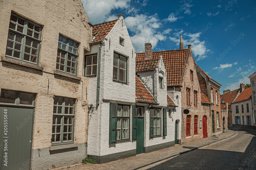 Brick facade of houses in typical style of the Flanders’s region in street of Bruges. With many canals and old buildings, this graceful town is a World Heritage Site of Unesco. Northwestern Belgium.