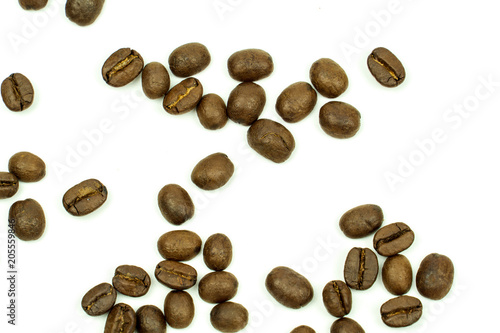 close up of medium or dark roasted coffee beans isolated on white background  can be used as a background or graphic object in your ads.