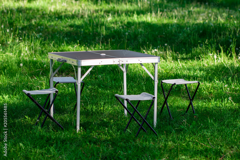 Beautiful picnic area with table and stools on the lawn Beautiful picnic area with table and stools on the lawn