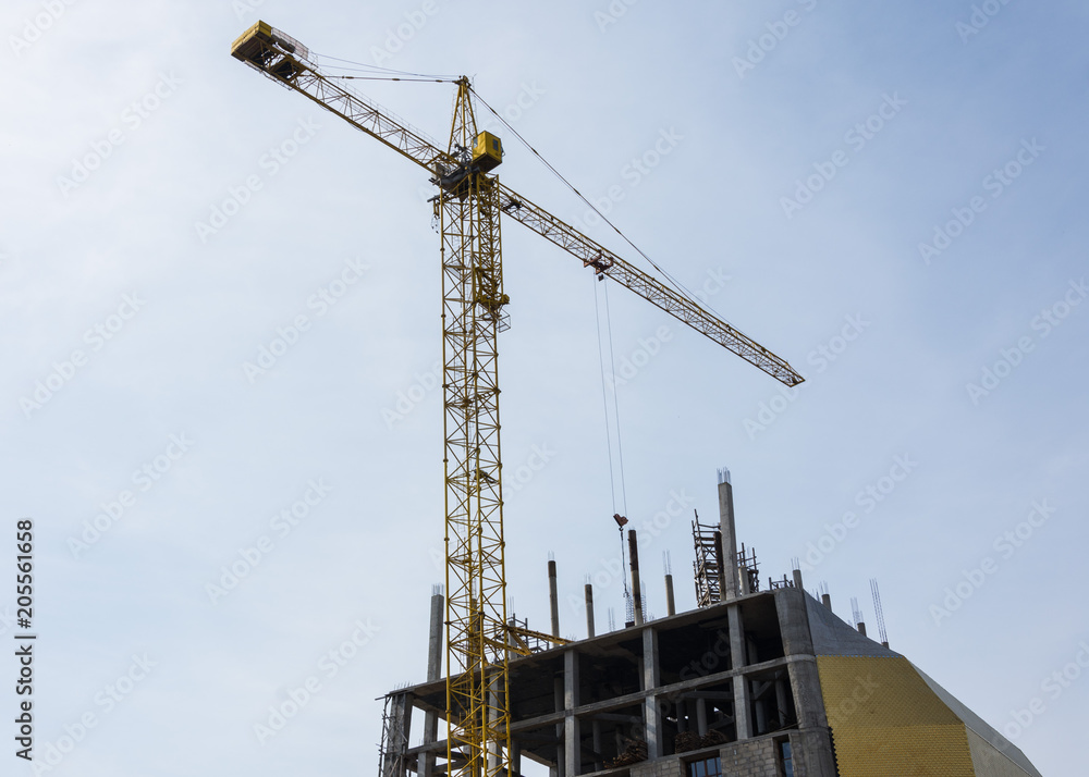 Construction with crane on blue sky background. Construction with crane on blue sky background.