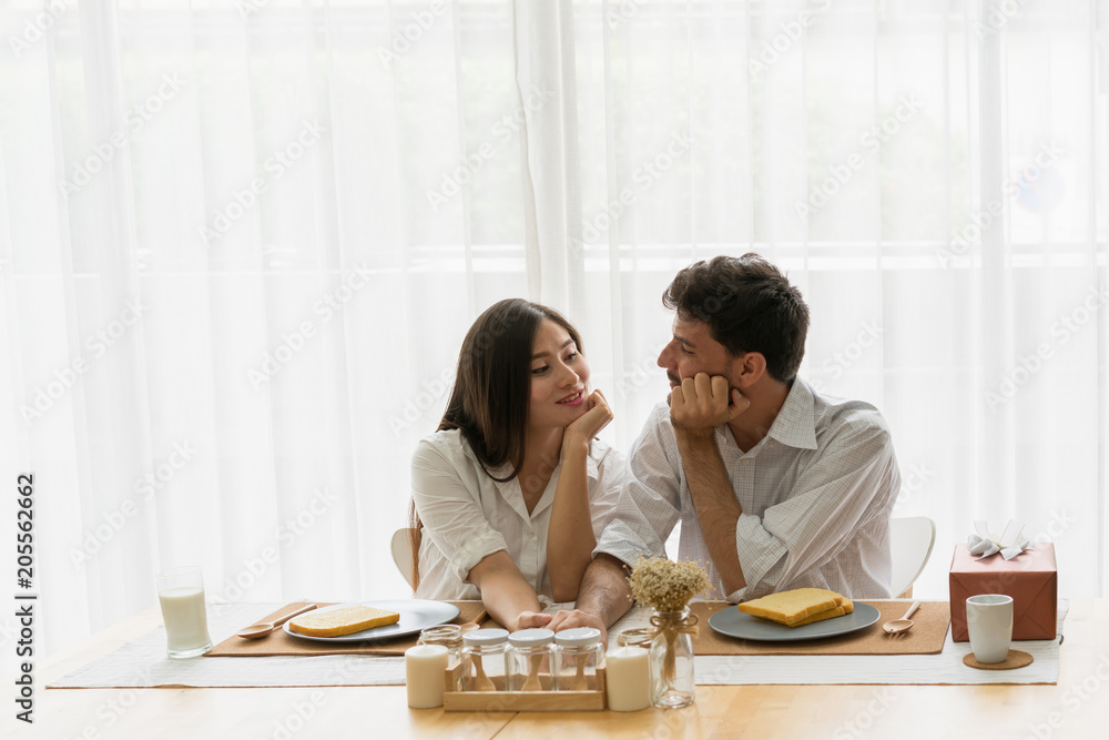 Very happy couple eating breakfast in the kitchen room at home. Concept of family, lover, romantic, dating and valentine. Very happy couple eating breakfast in the kitchen room at home. Concept of family, lover, romantic, dating and valentine.