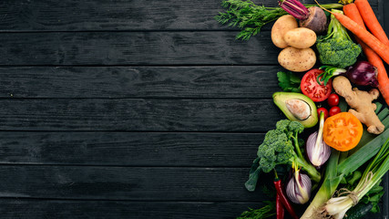 Healthy food. Vegetables and fruits. On a black wooden background. Top view. Copy space.