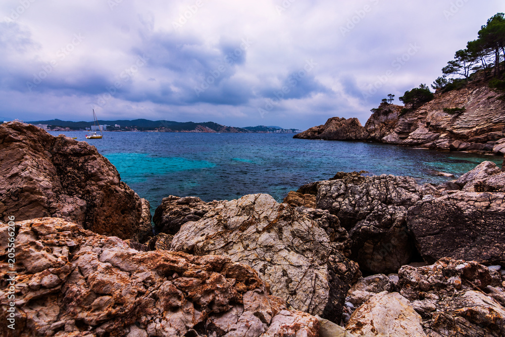 Mediterranean seascape with dramatic sky rocks and stones. In Spain