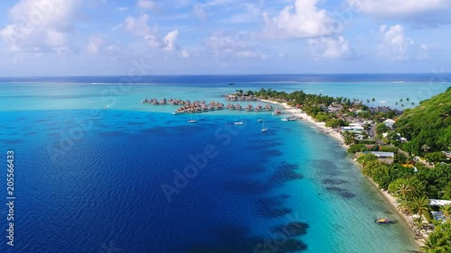 Aerial view of tropical paradise of Bora Bora island, turquoise crystal clear water of scenic blue lagoon, typical over water bungalows, Matira Point - South Pacific Ocean, French Polynesia from above photo