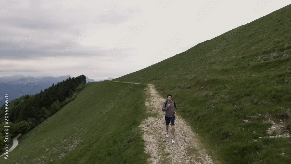 Young athletic man exploring mountains and running Young athletic man exploring mountains and running
