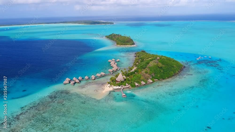 Aerial view of tropical paradise of Bora Bora island, turquoise crystal clear water of scenic lagoon, typical over water bungalows, Motu Piti 'U'u Uta (Sofitel) - South Pacific Ocean, French Polynesia Aerial view of tropical paradise of Bora Bora island, turquoise crystal clear water of scenic lagoon, typical over water bungalows, Motu Piti 'U'u Uta (Sofitel) - South Pacific Ocean, French Polynesia