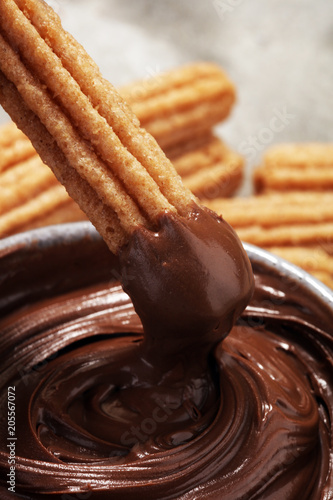 Traditional Spanish dessert churros with sugar and chocolate
