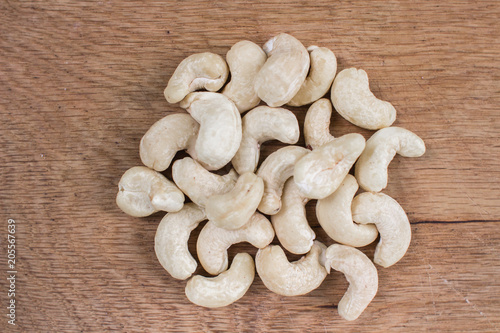 A handful of cashew nuts on a wooden table