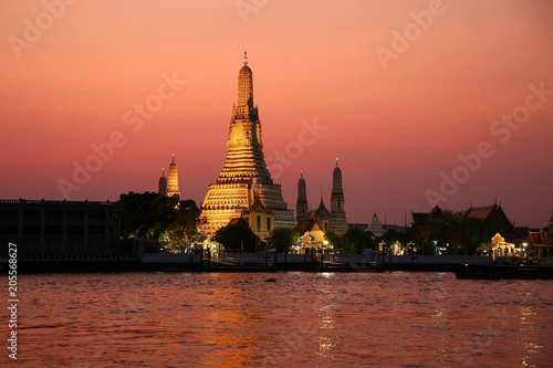 The temple of Dawn or Wat Arun on the bank of the Chao Phrya river at sunset  Bangkok  Thailand.