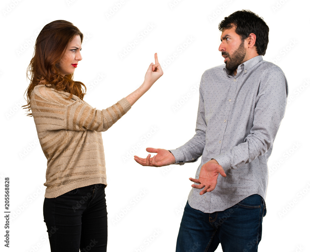 Young couple making horn gesture Young couple making horn gesture