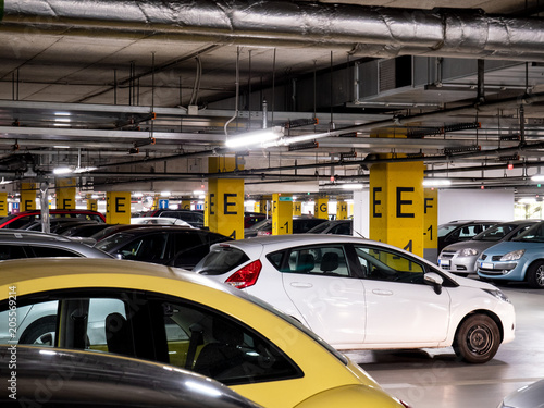 Underground garage in a shopping mall with a lot of cars