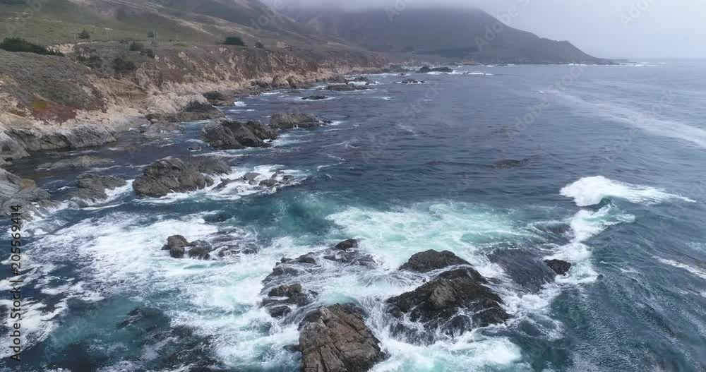 Flight over of rocky coastline. Aerial view of Ocean shore, waves crashing cliffs Flight over of rocky coastline. Aerial view of Ocean shore, waves crashing cliffs