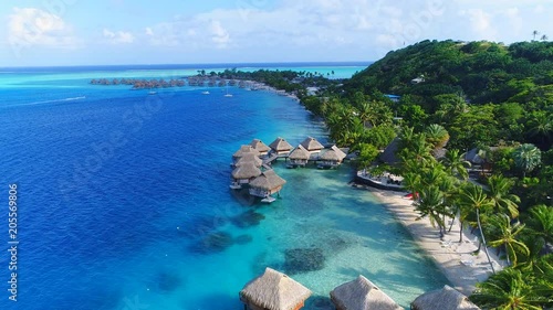 Aerial view of tropical paradise of Bora Bora island, turquoise crystal clear water of scenic blue lagoon, typical over water bungalows, Matira Point - South Pacific Ocean, French Polynesia from above photo