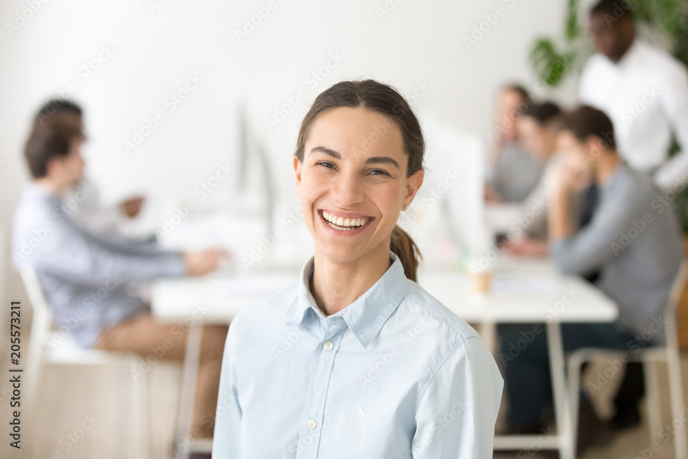 Cheerful happy millennial girl intern laughing looking at camera, attractive woman smiling posing, young professional employee, office worker or company manager starting career, headshot portrait Cheerful happy millennial girl intern laughing looking at camera, attractive woman smiling posing, young professional employee, office worker or company manager starting career, headshot portrait