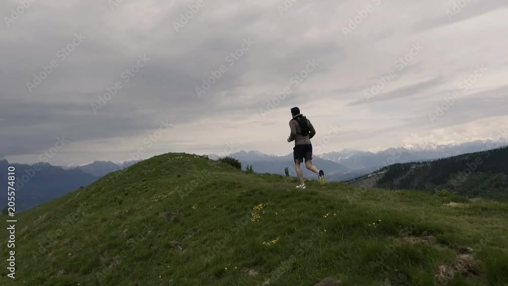 Tourist runner exploring mountains and jogging outdoors Tourist runner exploring mountains and jogging outdoors
