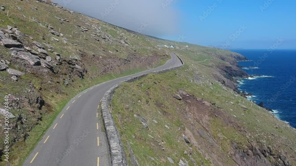 Amazing winding street along the coast line of Dingle Peninsula in Ireland - aerial shot Amazing winding street along the coast line of Dingle Peninsula in Ireland - aerial shot