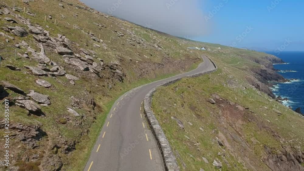 Amazing winding street along the coast line of Dingle Peninsula in Ireland - aerial shot Amazing winding street along the coast line of Dingle Peninsula in Ireland - aerial shot