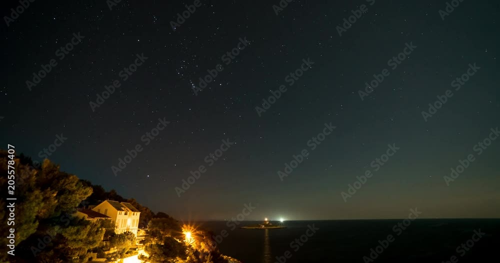 Stars passing over coast with ferry on island - time lapse Stars passing over coast with ferry on island - time lapse