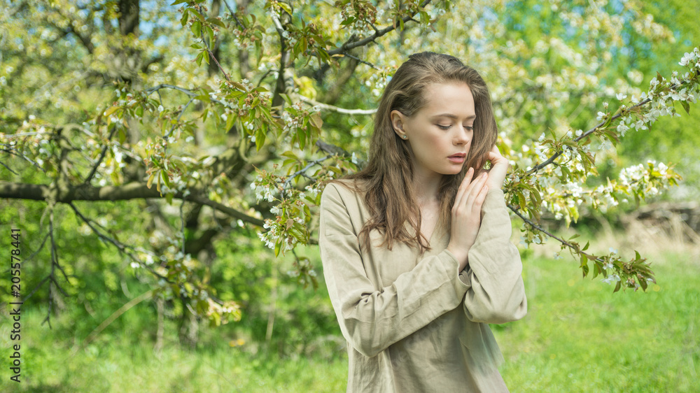 Beautiful girl in a spring blooming garden. The concept of youth, beauty Beautiful girl in a spring blooming garden. The concept of youth, beauty