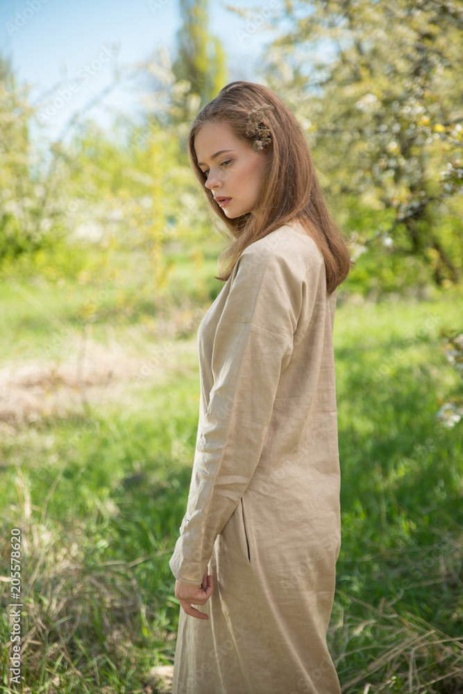 Beautiful girl in a spring blooming garden. The concept of youth, beauty Beautiful girl in a spring blooming garden. The concept of youth, beauty