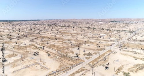 Aerial view of oil field, pumpjack. Aerial of oil pumps in desert - August 2017: Bakersfield, California, US
