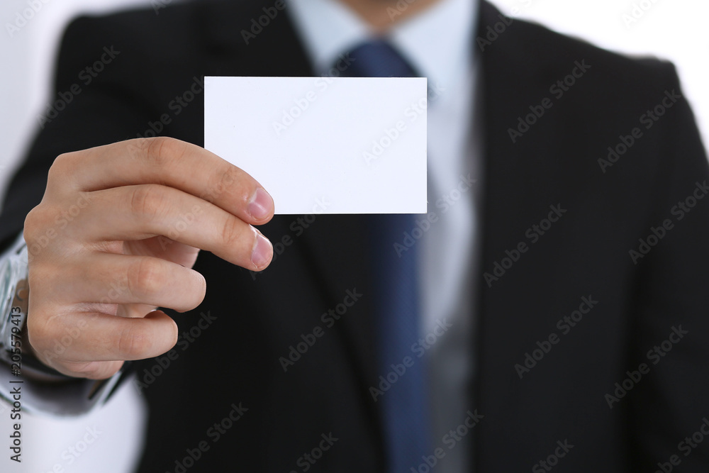 Businessman's hand holding business card with empty space Businessman's hand holding business card with empty space