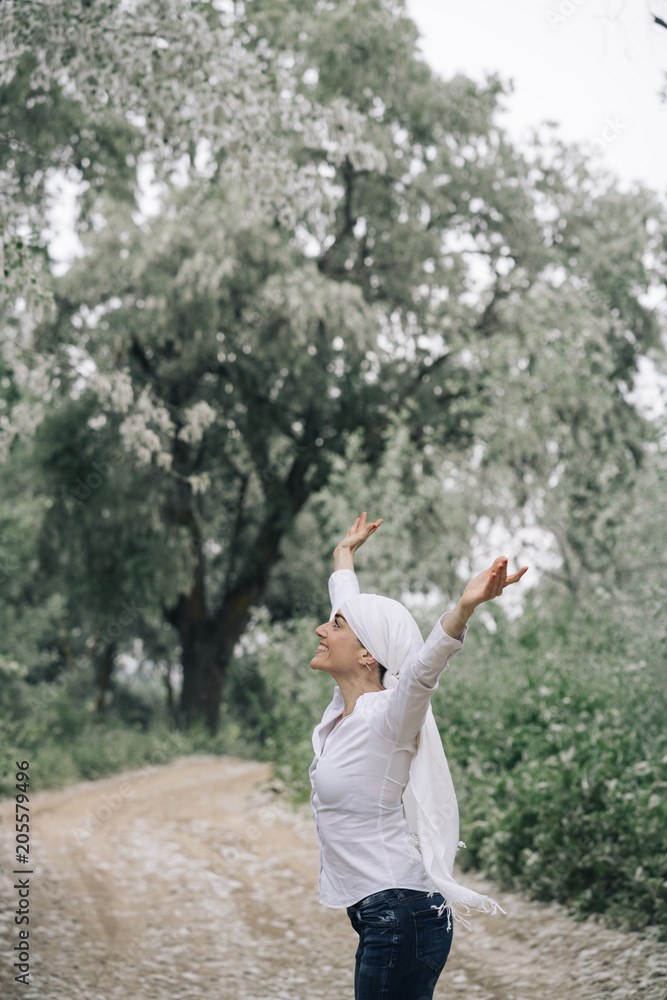 woman with white headscarf in the forest, has cancer woman with white headscarf in the forest, has cancer