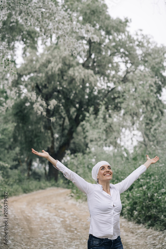 woman with white headscarf in the forest  has cancer
