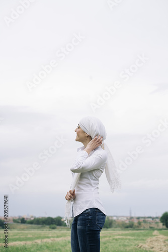 woman with white headscarf, has cancer © karrastock