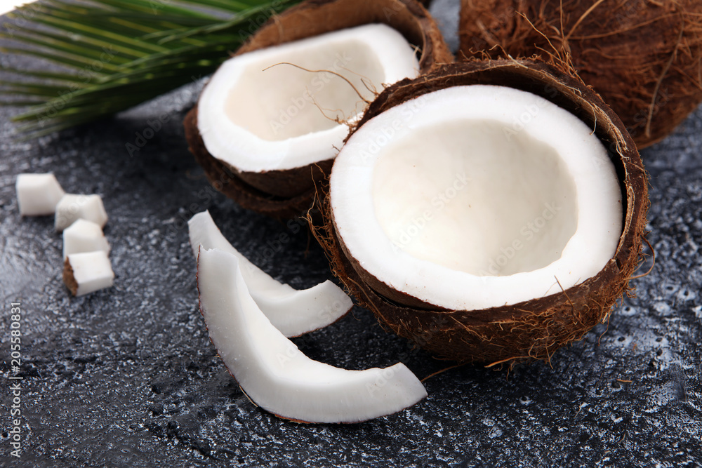 Ripe half cut coconut on a wooden background Ripe half cut coconut on a wooden background
