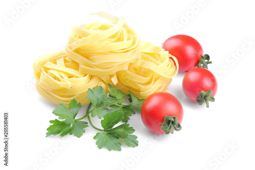 Fetuchini with several cherry tomatoes and a bunch of parsley. Isolated