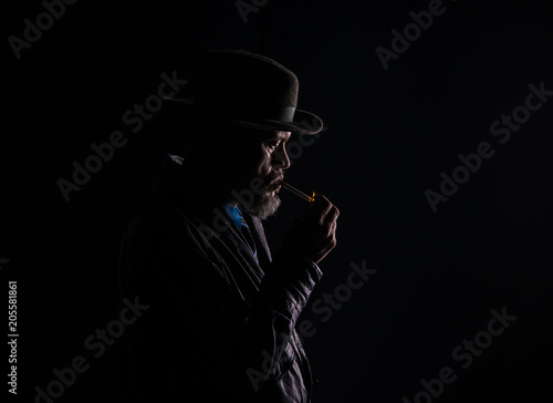 dark portrait, smoking man, black studio background