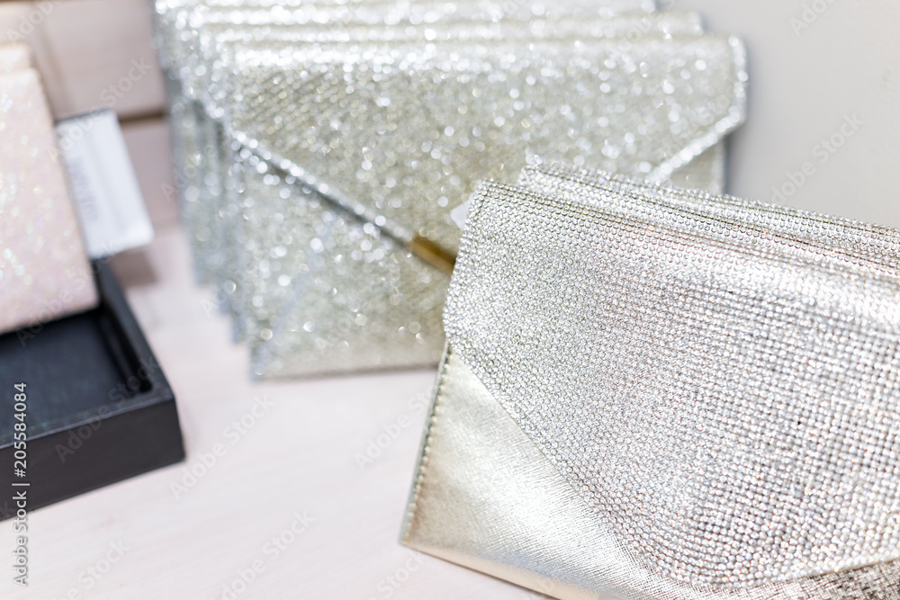Closeup of wedding luxury expensive shiny white purses in boutique discount store, many selection on shelf display with glittering rhinestones - obrazy, fototapety, plakaty 